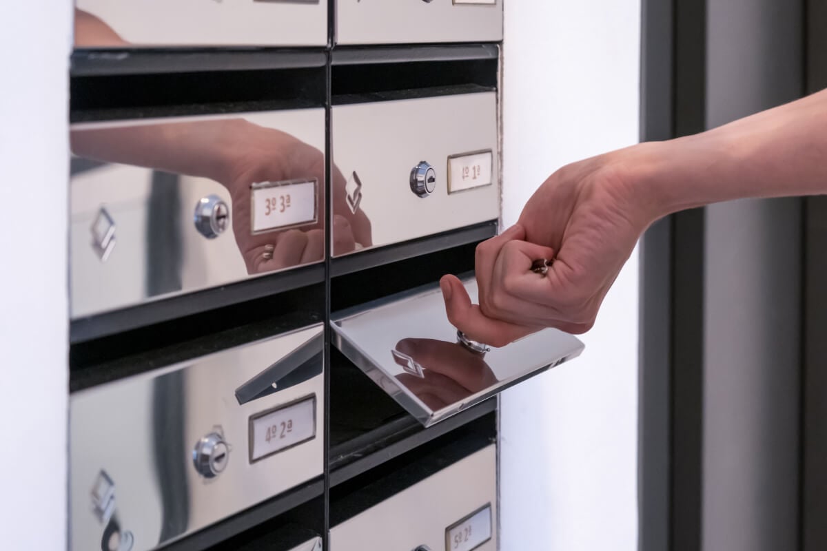 Hand opening a post office lockbox